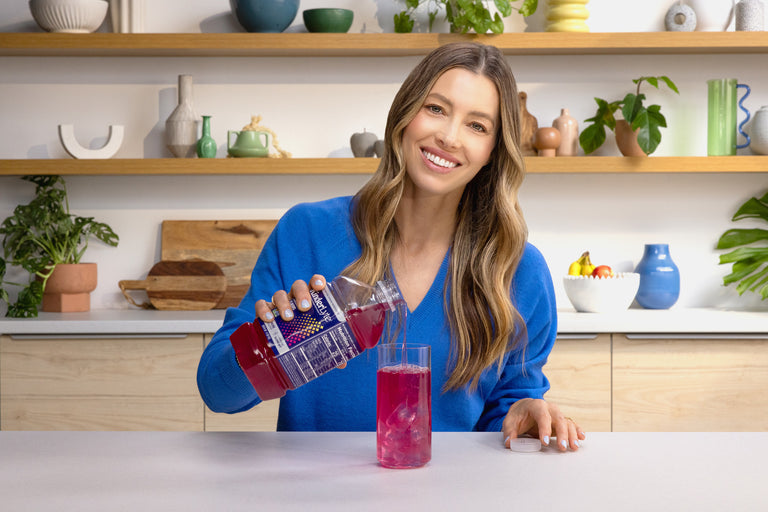 Jessica Biel pouring KinderLyte Advanced into a cup